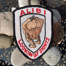 ALIBI Lookin' At Sights patch featuring guy with head up ass