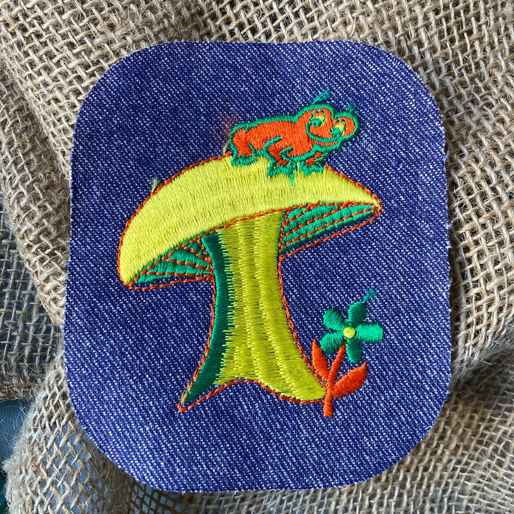 Vintage hippie patch with a frog on a mushroom toadstool, sewn on denim iron-on patch