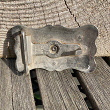 Small vintage western belt buckle featuring a horse head and stars