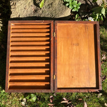 Antique wooden box with multiple little sections, hinged with clasps.