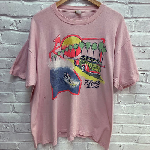Vintage pink surfing shirt from Puerto Rico with retro surf art graphic for sale.