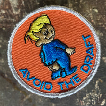 For sale is a Vintage Avoid the Draft embroidered patch, featuring a baby in a onesies that needs to be buttoned. 